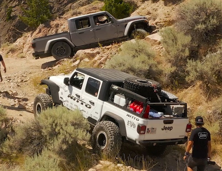 2 jeep gladiators rock climbing on a hill